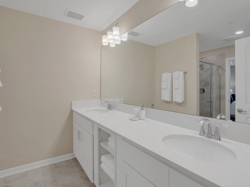 Master bathroom with double vanities and shower.