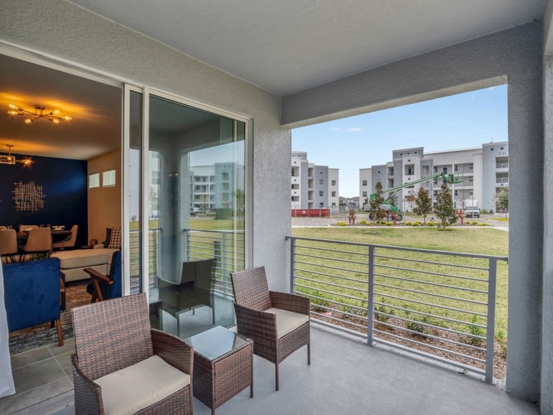 Access to a private balcony with comfortable seating.