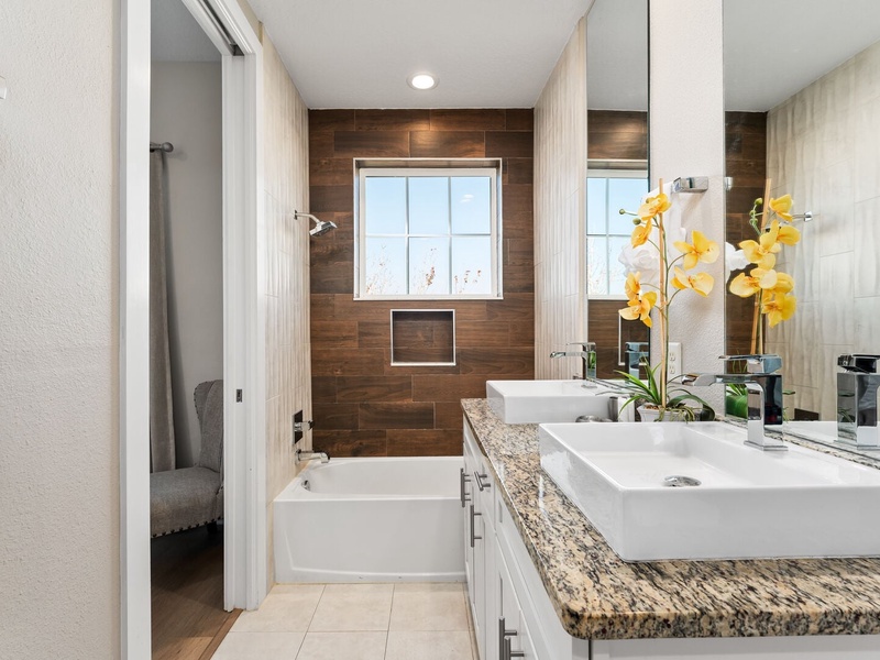 Our master bathroom features a double vanity,  bathtub and shower.