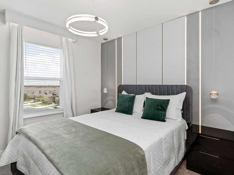 This guest room features one queen size bed and its own bathroom.
