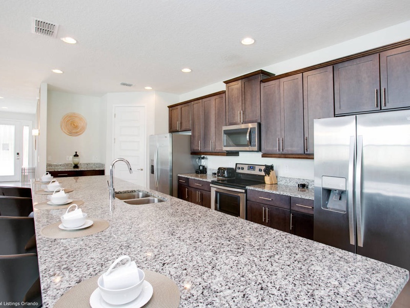 Fully equipped kitchen with stainless steel appliances.
