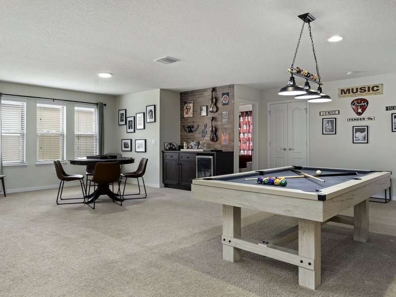 Looking for more entertainment? Our second TV room offers a pool table, a poker table, and plenty of cozy seating for a perfect movie nights