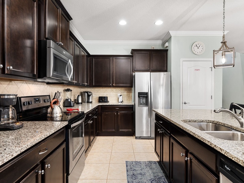The kitchen features stainless steel appliances with all you need to prepare delicious meals.