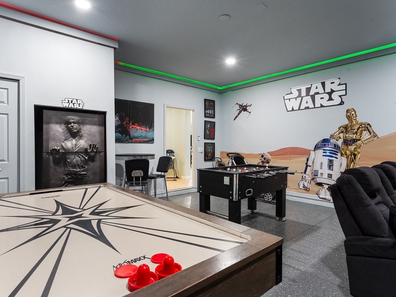 Featuring an air hockey table, arcade game and a foosball table.