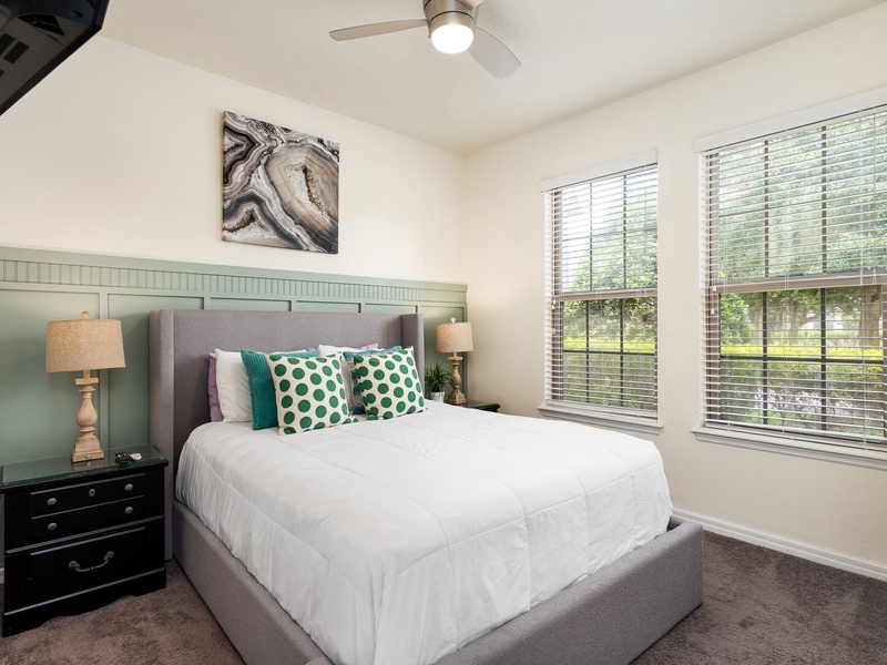 The first bedroom on the main floor offers its own private bathroom and a TV.