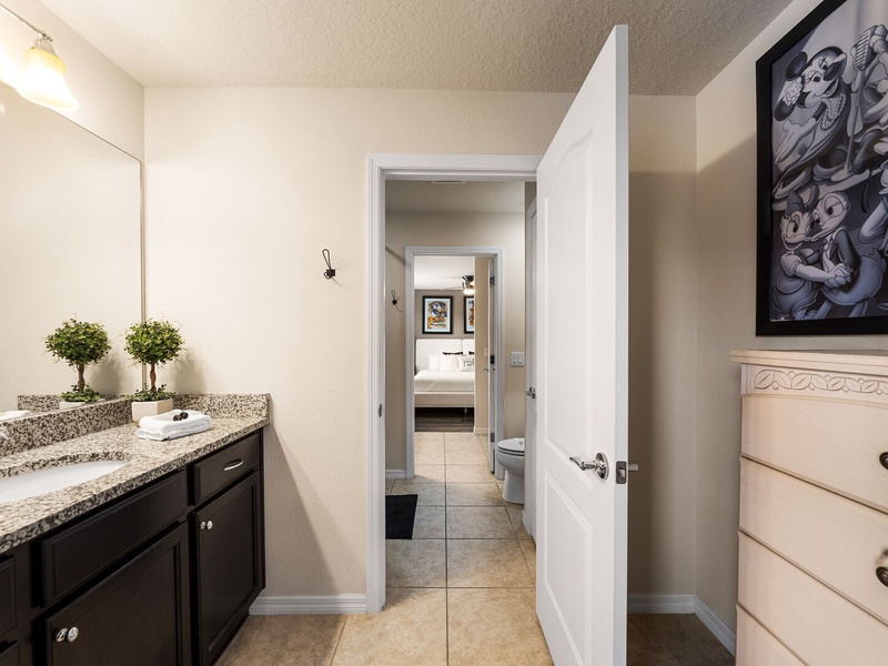 The sixth bathroom conveniently interconnects two guest rooms, each featuring its own private vanity.