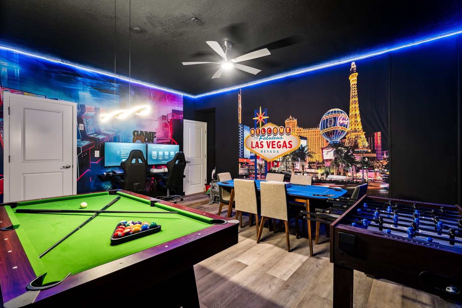 Game room with pool table, foosball table, and game consoles, perfect for family fun and entertainment