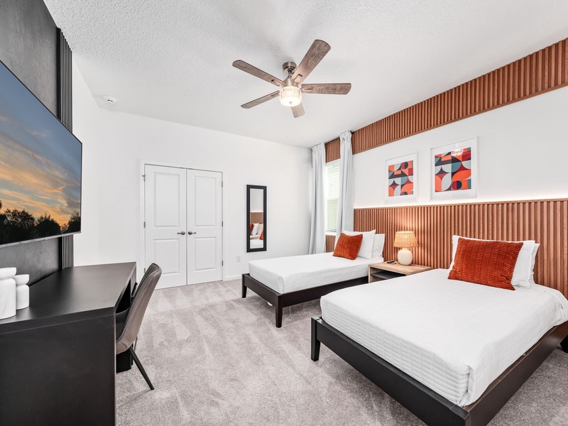 Each bedroom features comfortably appointed beds, a work desk, TV, and a private ensuite bathroom.