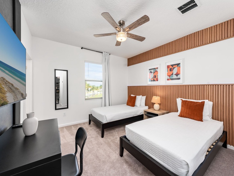 Each bedroom features comfortably appointed beds, a work desk, TV, and a private ensuite bathroom.
