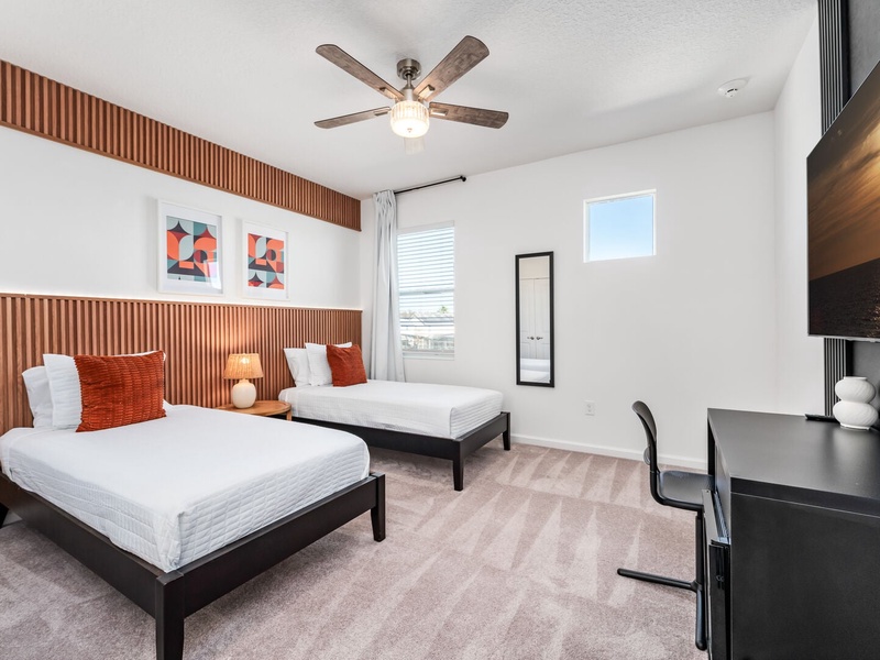 Each bedroom features comfortably appointed beds, a work desk, TV, and a private ensuite bathroom.