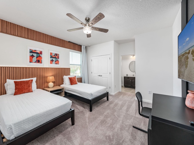 Each bedroom features comfortably appointed beds, a work desk, TV, and a private ensuite bathroom.