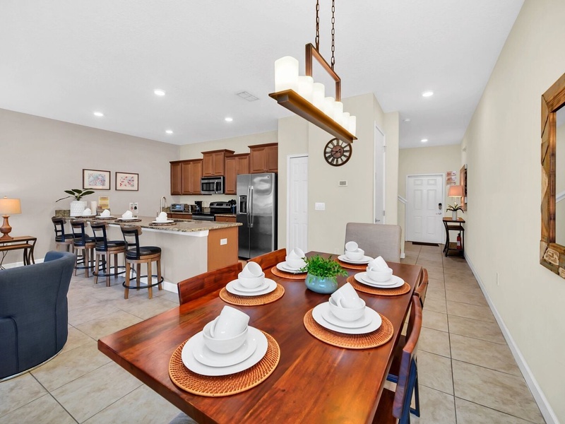The dining area comfortably seats 6 people, with 4 additional stools at the kitchen bar.