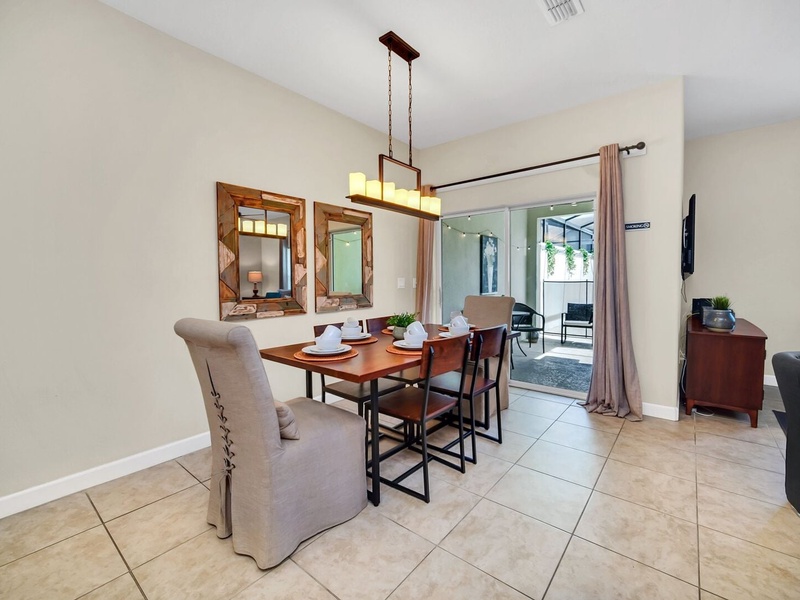 The dining room perfectly integrates with the rest of the house, as well as the outside area with BBQ grill and pool.