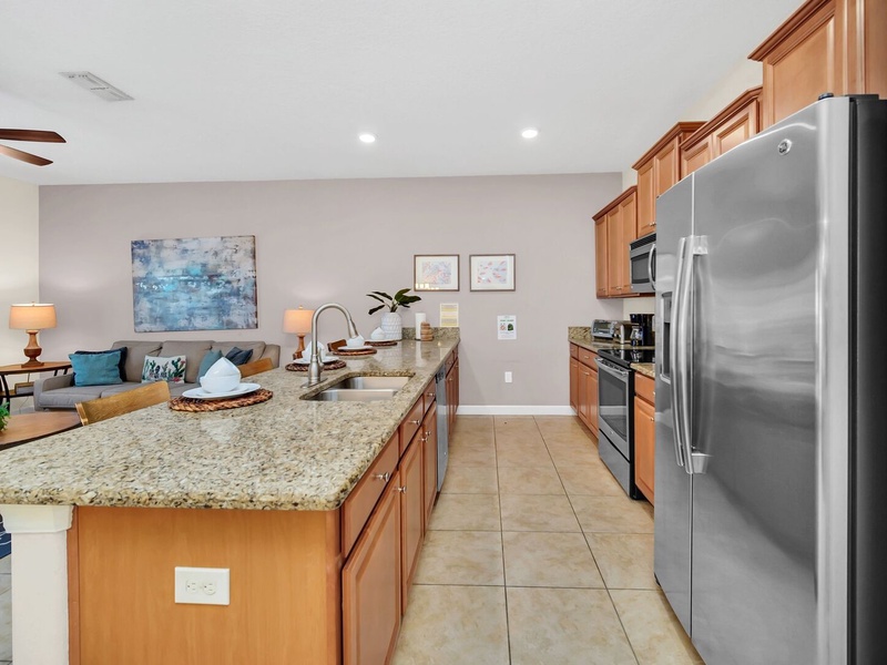 The kitchen features stainless steel appliances and granite countertops.