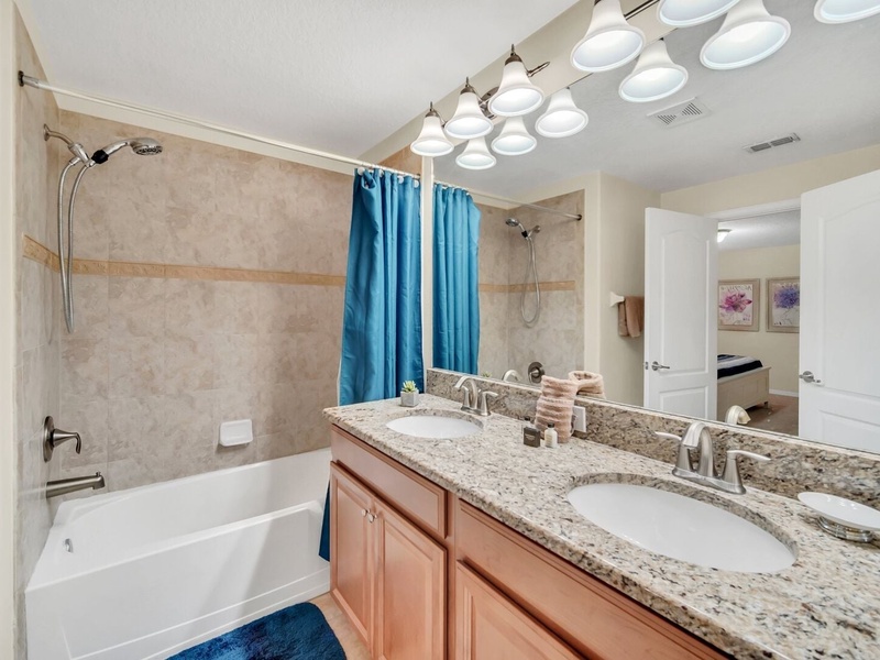 High-quality master bathroom with a double vanity and combo tub shower.