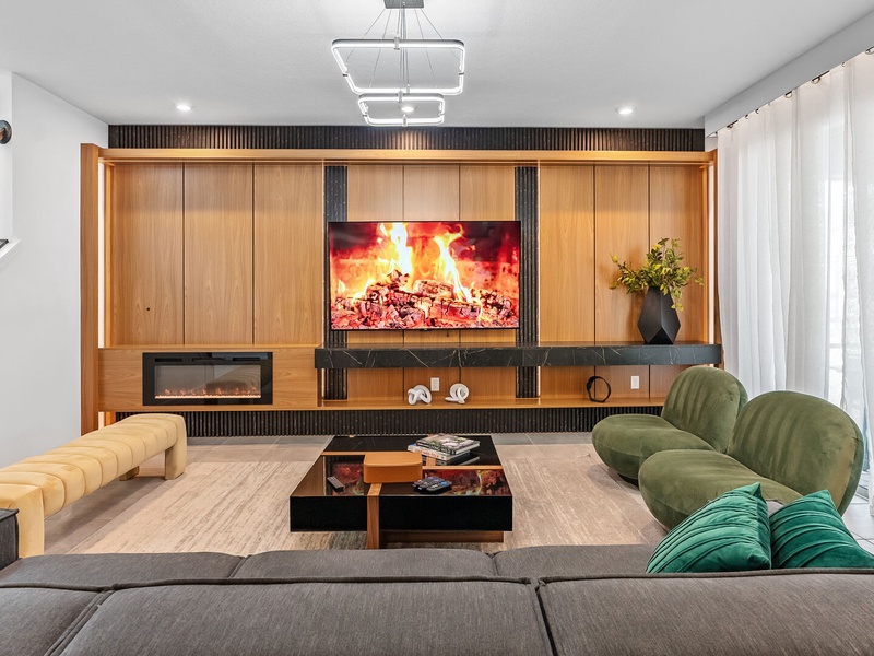 Enjoy cozy movie nights by the fireplace with comfortable seating.