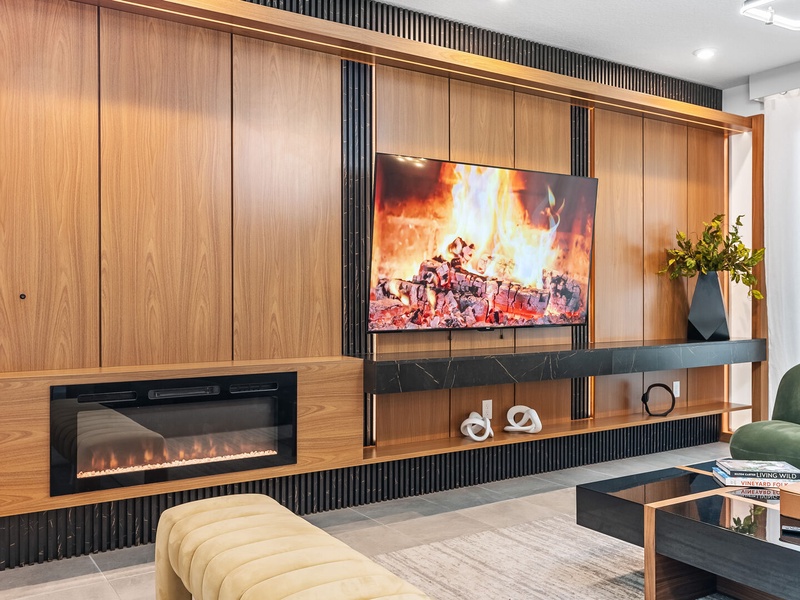 Enjoy cozy movie nights by the fireplace with comfortable seating.