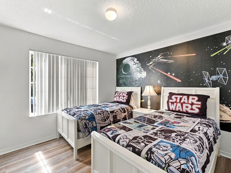 Fun themed twin bedroom designed to make family vacations more memorable for kids.