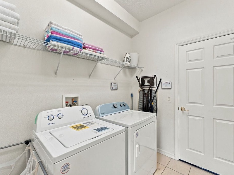 Private laundry room with washer and dryer for convenient longer stays.