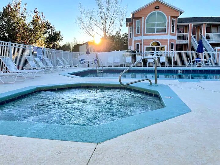Relax by the community pool and spa at Villas at Island Club in Kissimmee, Florida.