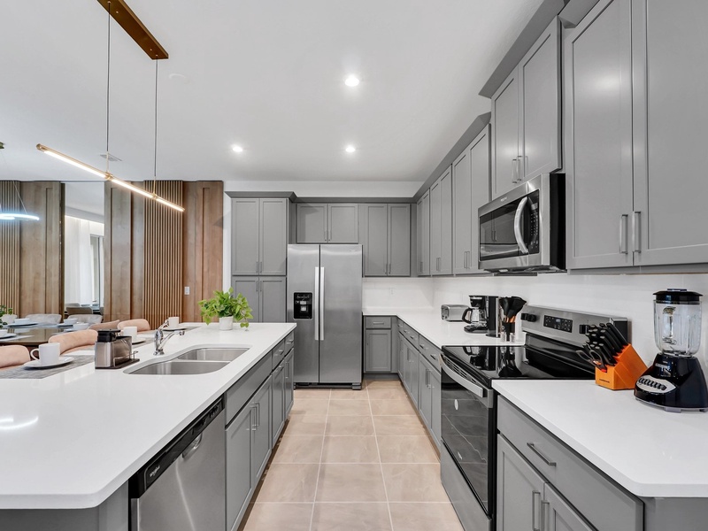 Cook your favorite meals in this stylish, fully equipped kitchen with a spacious island and modern appliances.