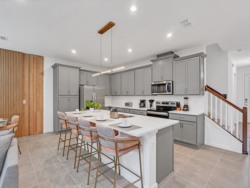 Cook your favorite meals in this stylish, fully equipped kitchen with a spacious island and modern appliances.