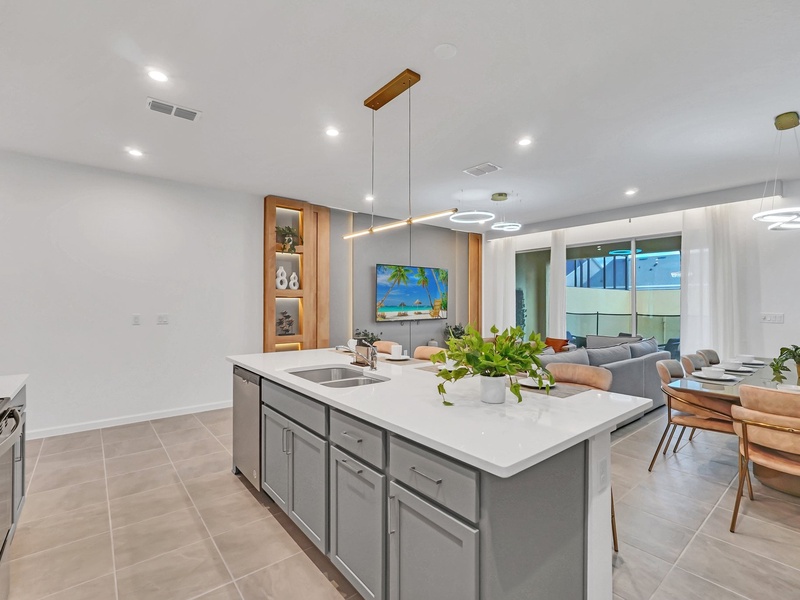 Cook your favorite meals in this stylish, fully equipped kitchen with a spacious island and modern appliances.