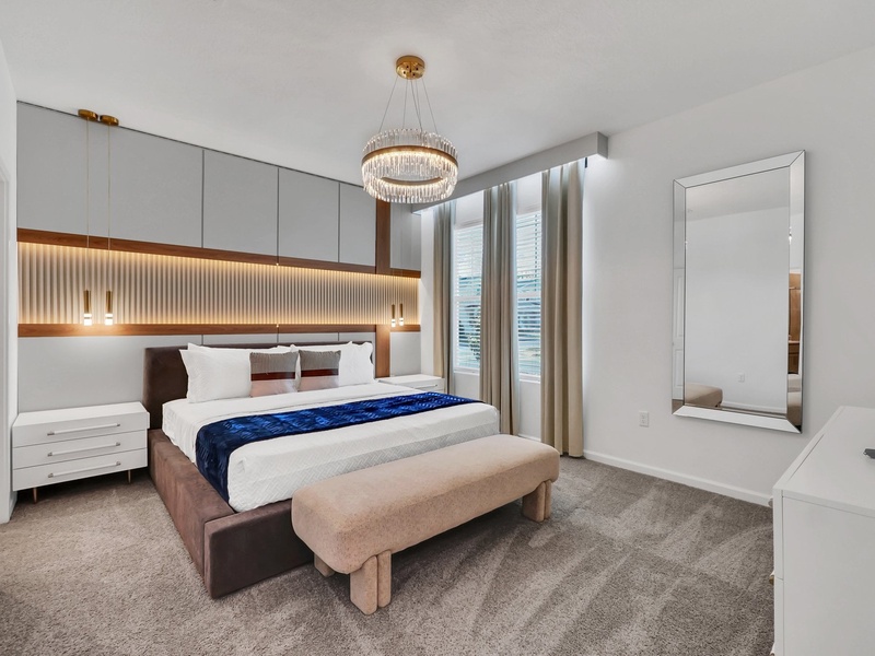 Relax in this comfortable first-floor master bedroom featuring a private ensuite bathroom for added convenience and privacy.
