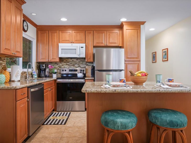 Updated kitchen with stainless steel appliances, granite countertops, and a breakfast bar perfect for casual dining.