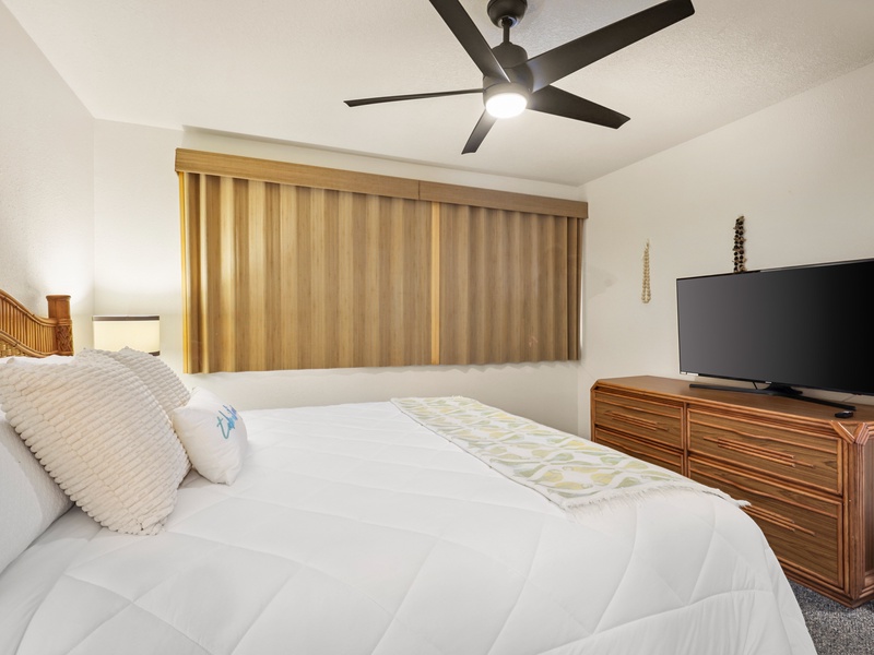 Relax in comfort with a plush king-size bed, custom window treatments, tropical furnishings, and a large flat-screen, smart TV—ideal for unwinding after a day in the sun