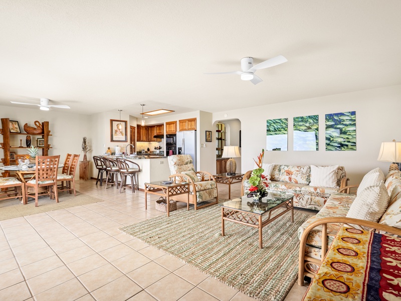 Open-concept living, dining, and kitchen area with tropical flair—perfect for gathering with family or friends after a day in paradise