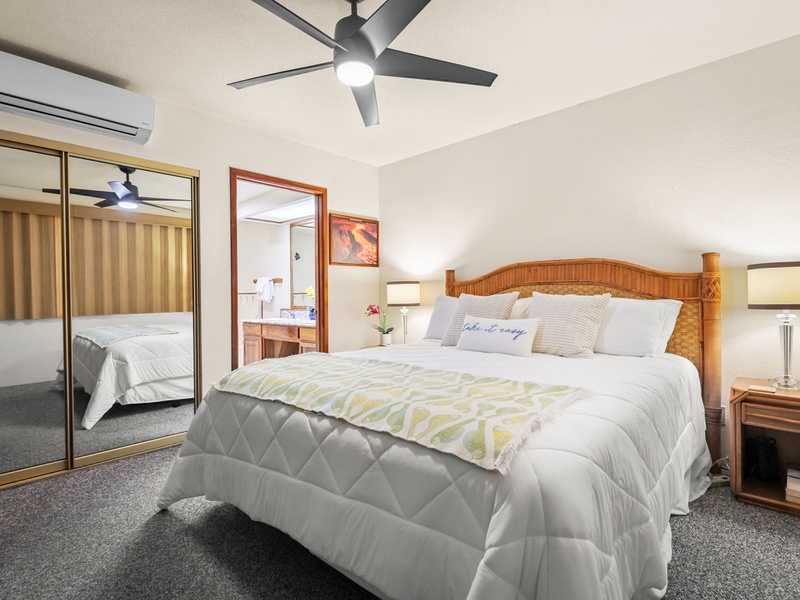 Rest easy in this inviting primary bedroom featuring a king bed, ensuite bath, air conditioning, and tropical furnishings that create a serene, island-inspired retreat