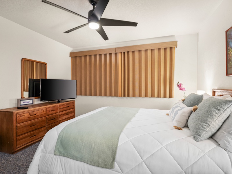 Settle into this cozy guest suite featuring a queen-size bed, soft neutral decor, custom blinds, and a flat-screen TV—perfect for restful nights and lazy mornings