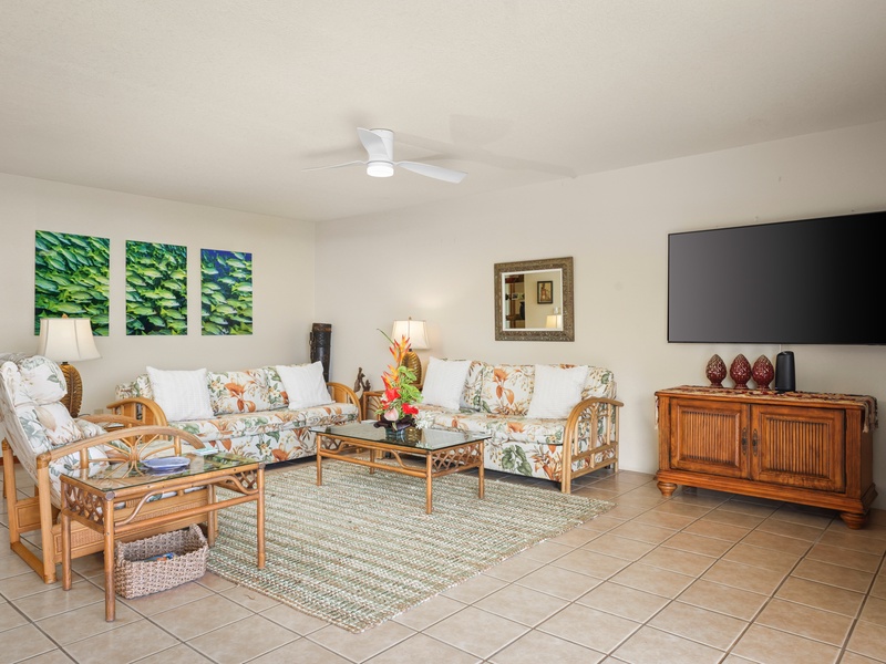 Comfortable, spacious living area with tropical decor and a large flat-screen TV—perfect for movie nights after a day in the sun