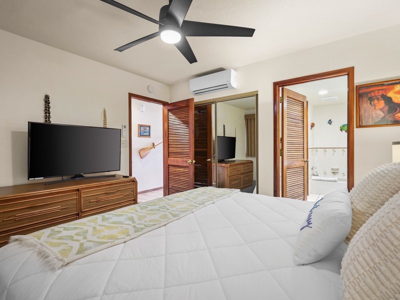 This tranquil bedroom includes a plush king bed, flat-screen TV, and private bathroom. Stay cool with split A/C and enjoy easy access to both the ensuite and main hallway