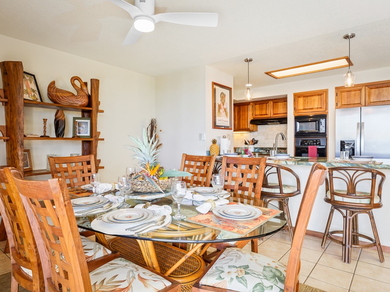 Gather around the elegant glass-top table surrounded by island-inspired decor, with a beautiful open kitchen and bar seating just steps away.