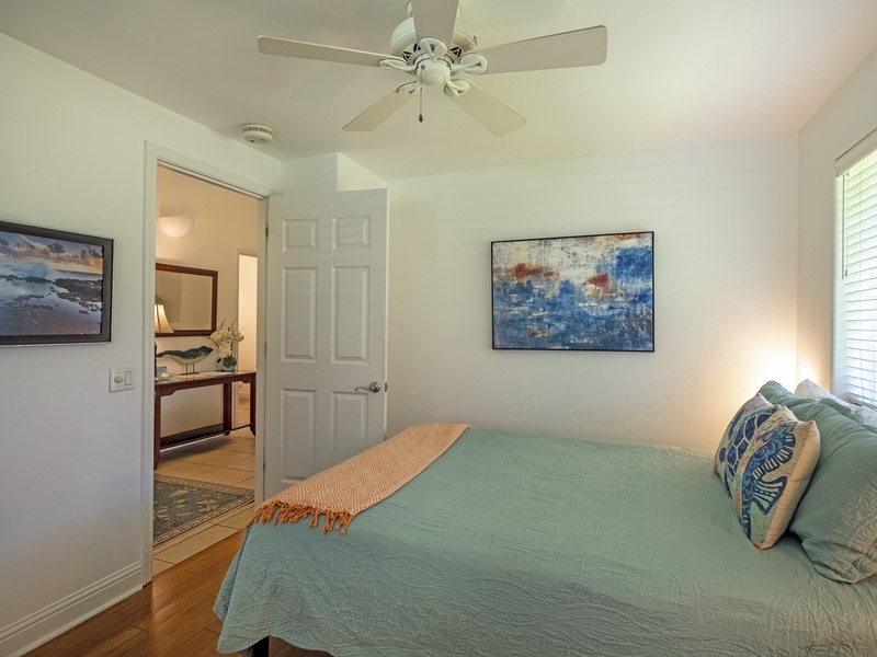 There are plenty of windows in the guest bedroom, making the space feel light and airy, and a ceiling fan to help keep everything nice and cool!