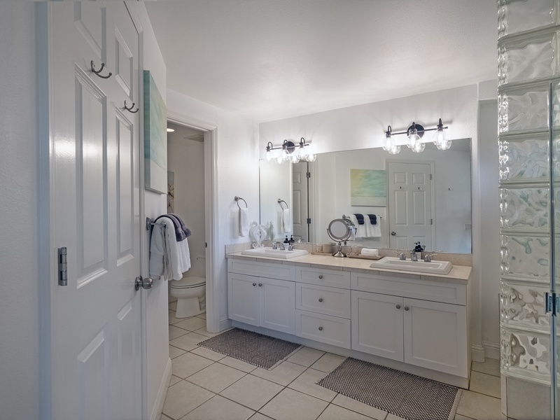 Back inside, the grand master suite has a spacious and well-lit bathroom. 
