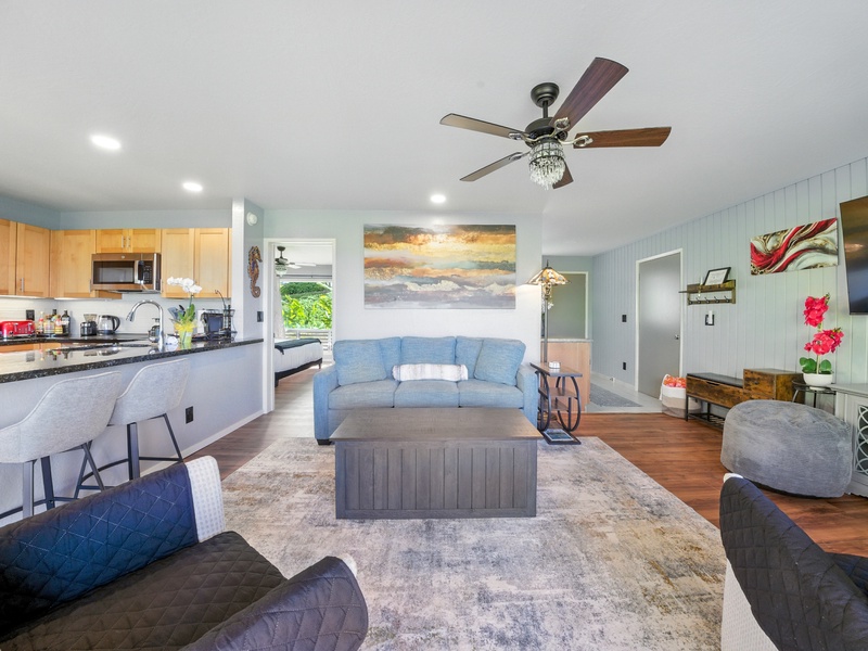 The living room, kitchen, and dining area all flow seamlessly together, making it easy to enjoy your traveling companions' company from wherever you are in the condo!
