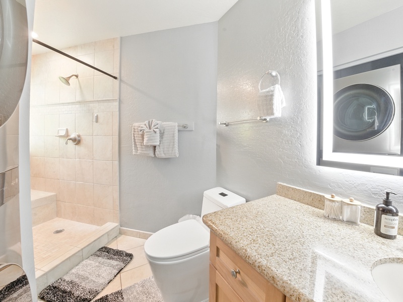 The ensuite bathroom is spacious and well-lit, so you can spread out and take your time getting ready or unready!