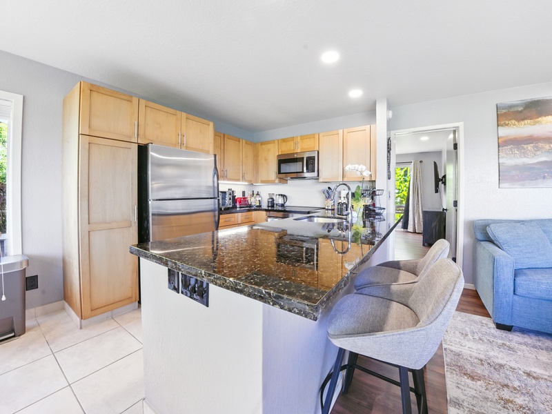 The full kitchen and bar-top seating. Through the doorway in the center of the picture are the bedroom and ensuite bathroom. 