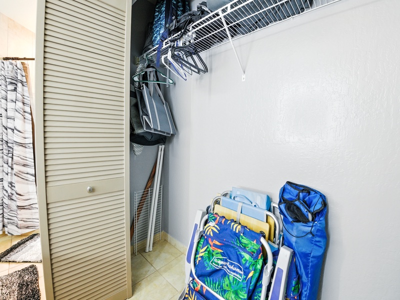 The storage closet in the bathroom, which conveniently holds a modest array of beach gear including: beach towels, beach chairs, a soft-sided cooler, and a few other goodies!
