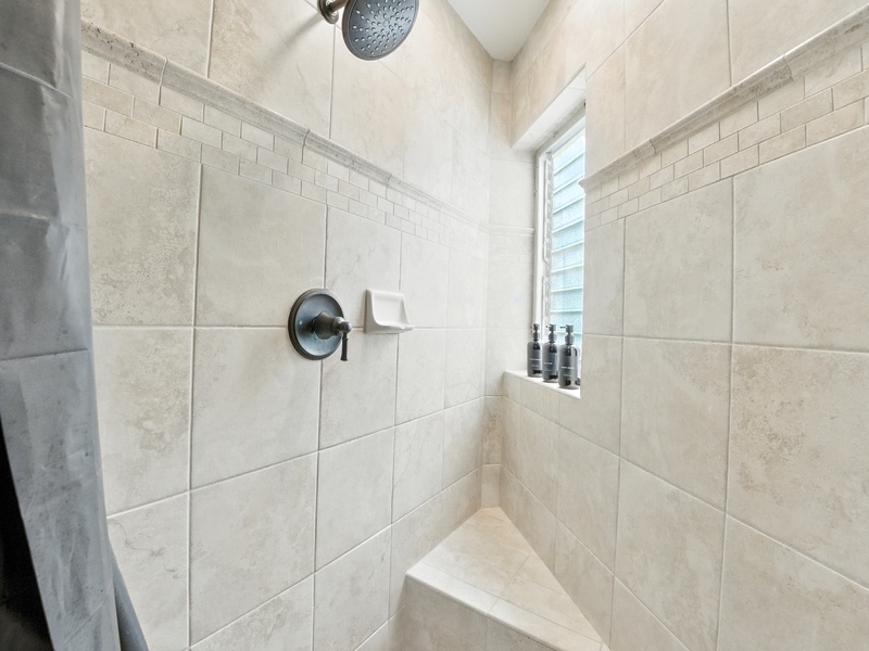 The walk-in shower also features a corner bench seat, which is ideal for mobility issues and shaving legs alike!