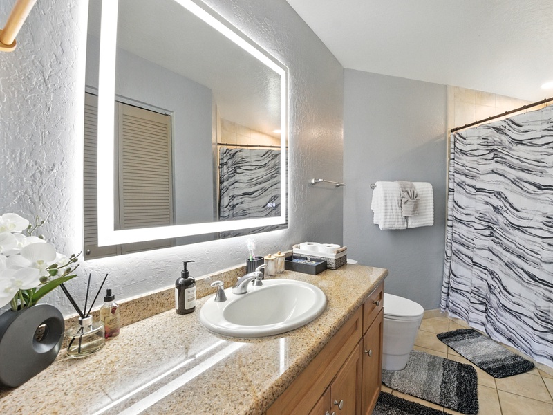 The bathroom in Pali Ke Kua 131 features bright vanity lighting, perfect for your morning and night time routines, as well as plenty of counter and cabinet space for all your toiletries.