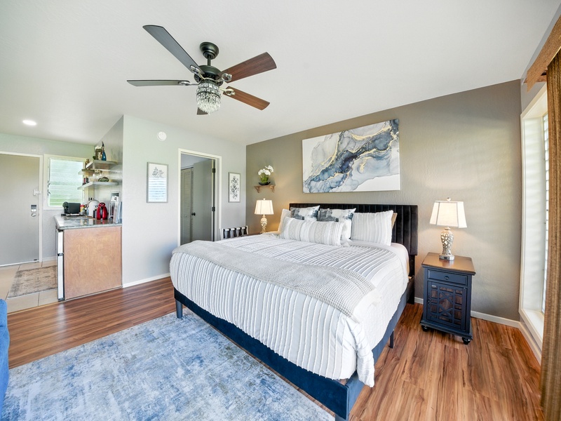 The bedroom and living area, featuring a comfy queen bed where you can rest and recharge after a long day.