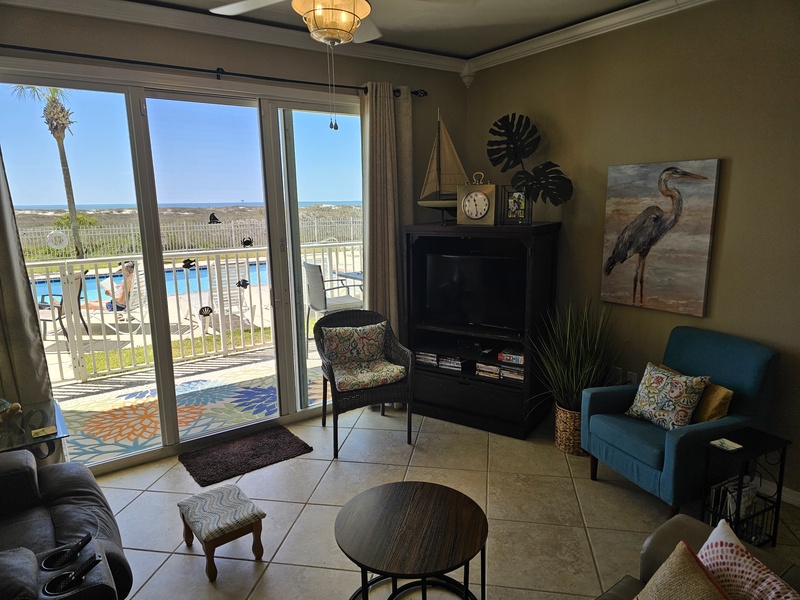 Living Room walks out to pool and beach. 