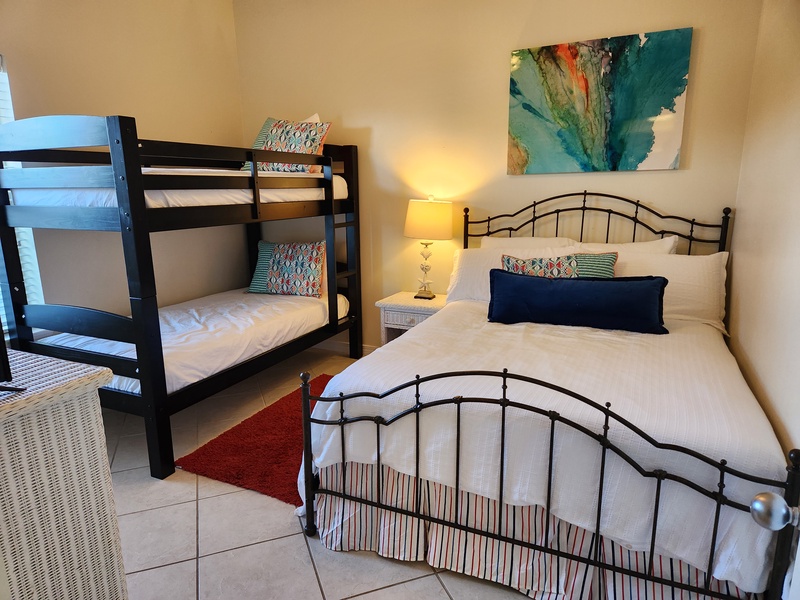 2nd bedroom has queen bed with bunk beds. 