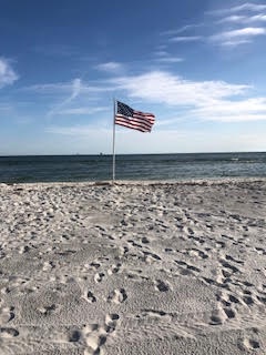 American flag on the beach