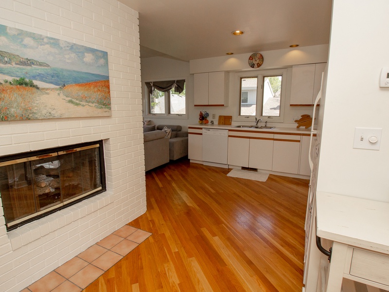 2nd level view of fireplace and kitchen.