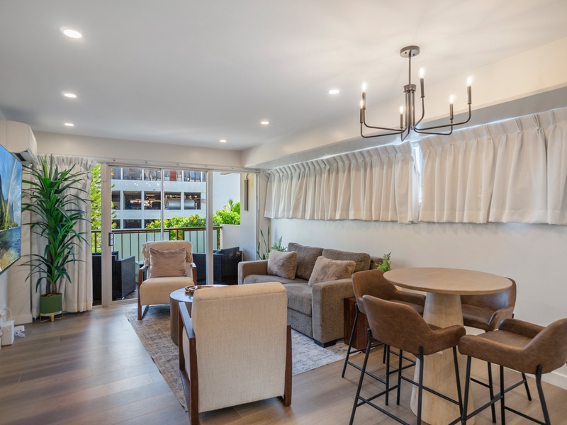 Gather in a spacious living room filled with natural light and tropical touches;perfect for relaxing after exploring Waikiki.